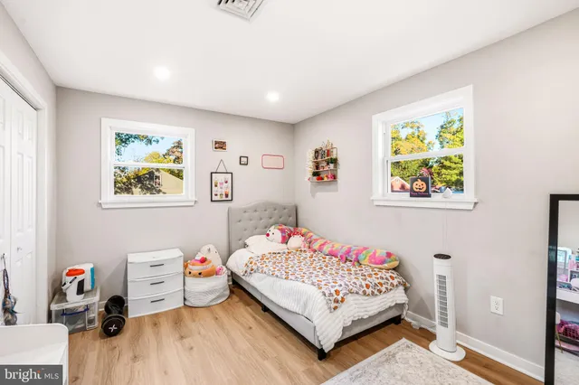 a view of a hallway to a livingroom and a dinning area with furniture