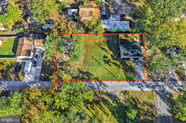 a view of swimming pool with a yard and plants