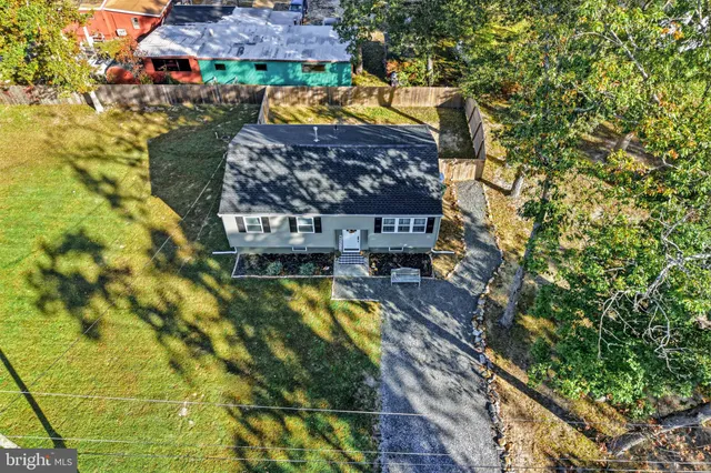 a view of a hallway with wooden floor and stairs
