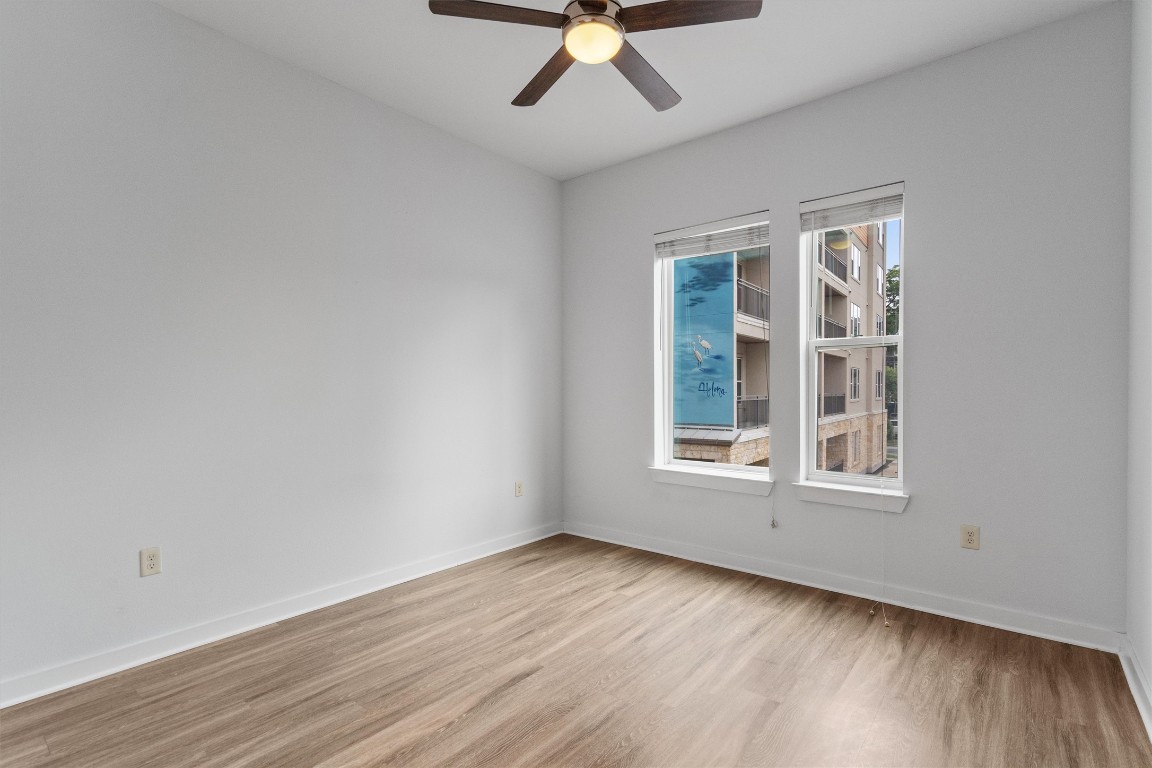 1900 Barton Springs Road, Unit 2027 Austin, TX 78704 - Photo 13 of 28 Spare room featuring light wood-style flooring and ceiling fan