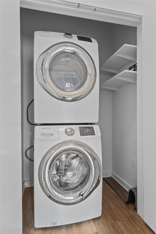 1900 Barton Springs Road, Unit 2027 Austin, TX 78704 - Photo 23 of 28 Washroom featuring stacked washer / dryer and wood finished floors