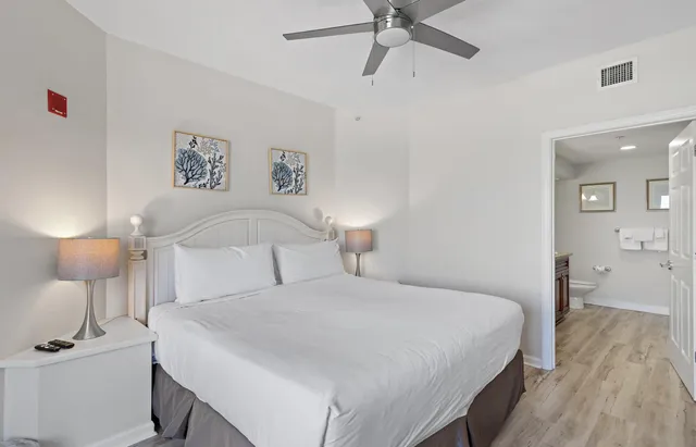 a bedroom with a bed and painting on the wall