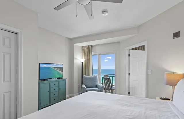 a bedroom with a bed and a mirror on dresser