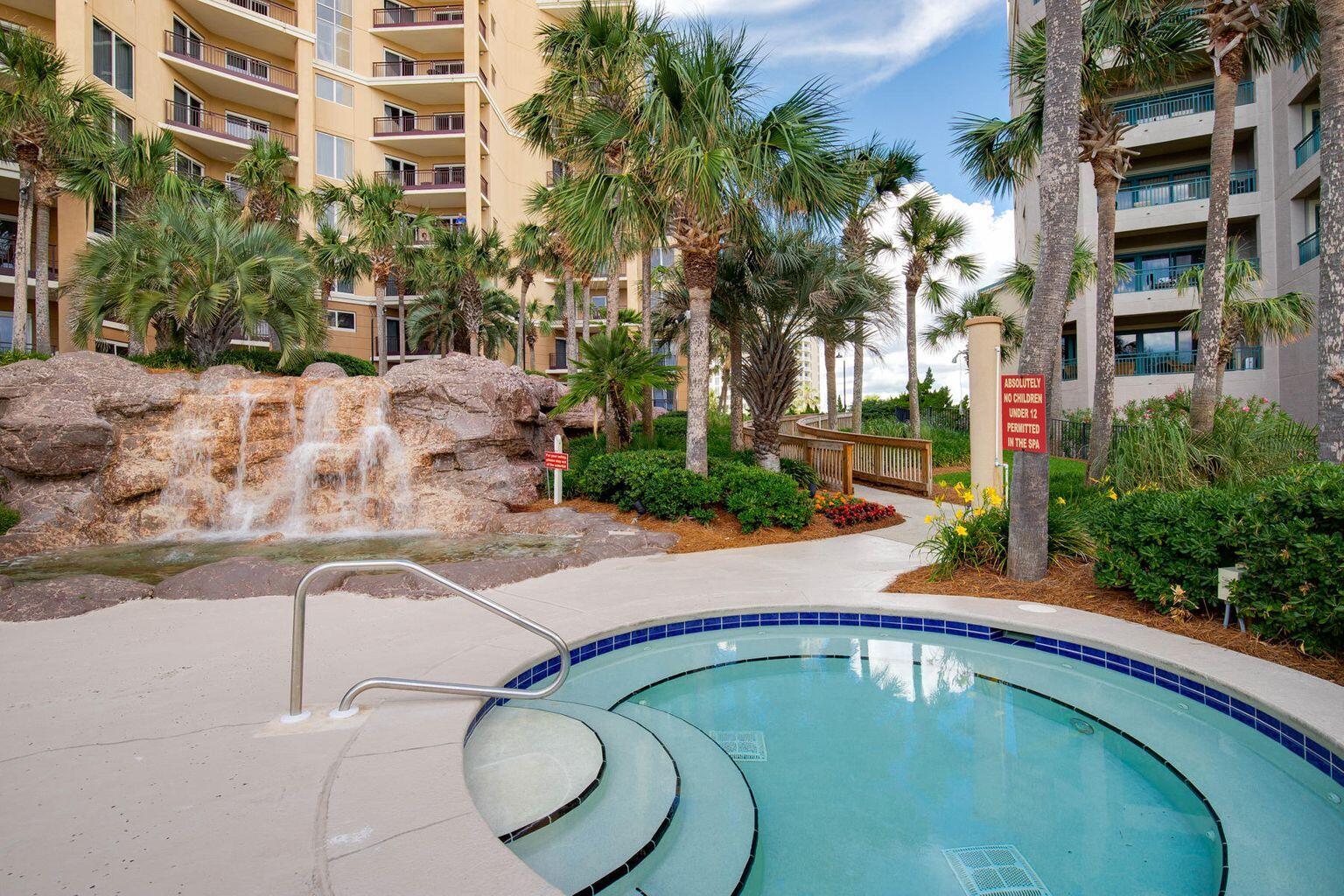 4789 Westwinds Drive, Unit 4789 Miramar Beach, FL 32550 - Photo 29 of 32 a swimming pool with outdoor seating and yard