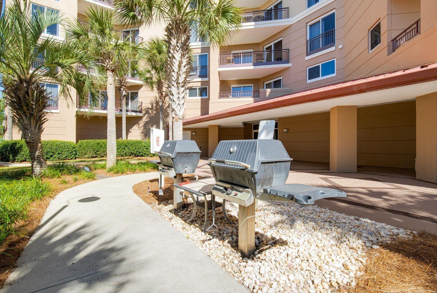 4789 Westwinds Drive, Unit 4789 Miramar Beach, FL 32550 - Photo 30 of 32 a view of a patio with a table and chairs and potted plants