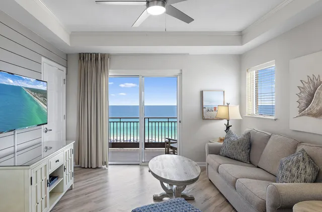 a living room with furniture a flat screen tv and a window