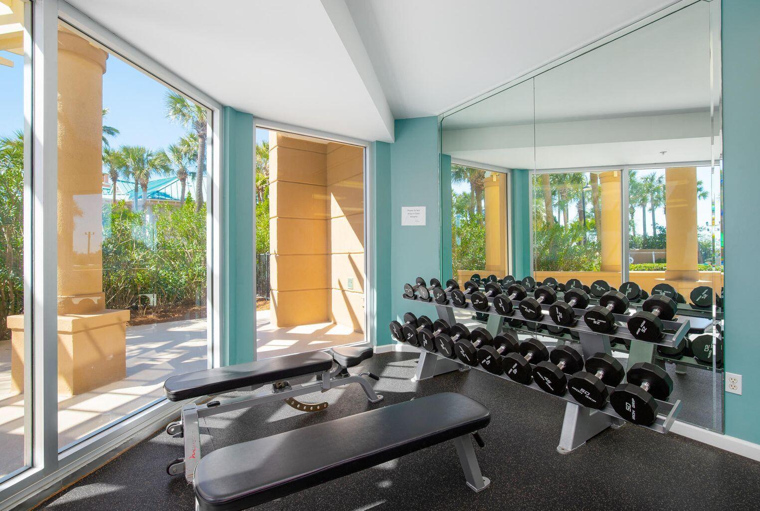 4789 Westwinds Drive, Unit 4789 Miramar Beach, FL 32550 - Photo 32 of 32 a room with gym equipment and large windows