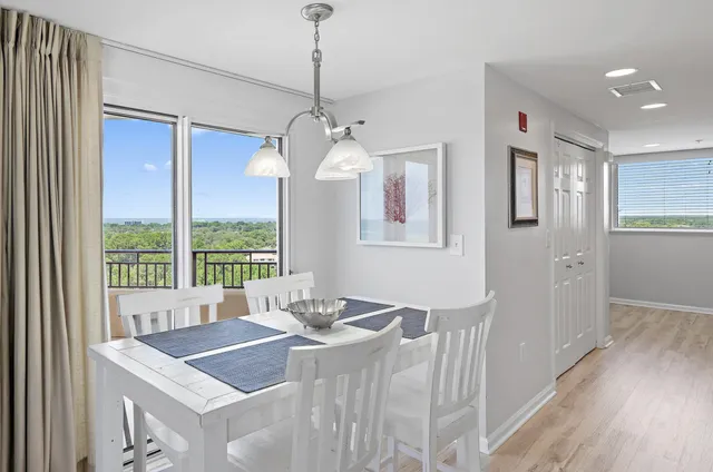 a view of a dining room with furniture window and wooden floor