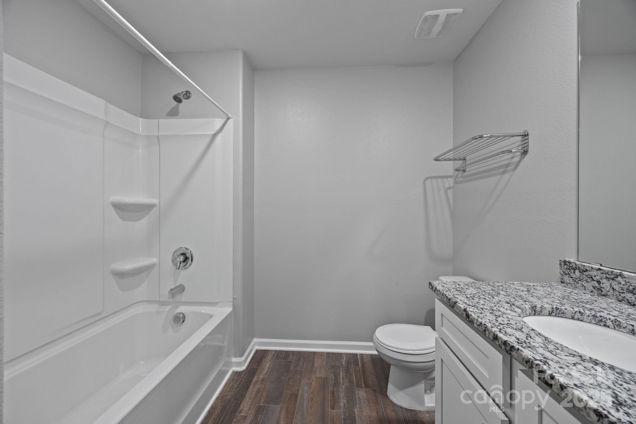 163 Kipling Lane Kings Mountain, NC 28086 - Photo 32 of 46 a bathroom with a granite countertop toilet a sink and bathtub