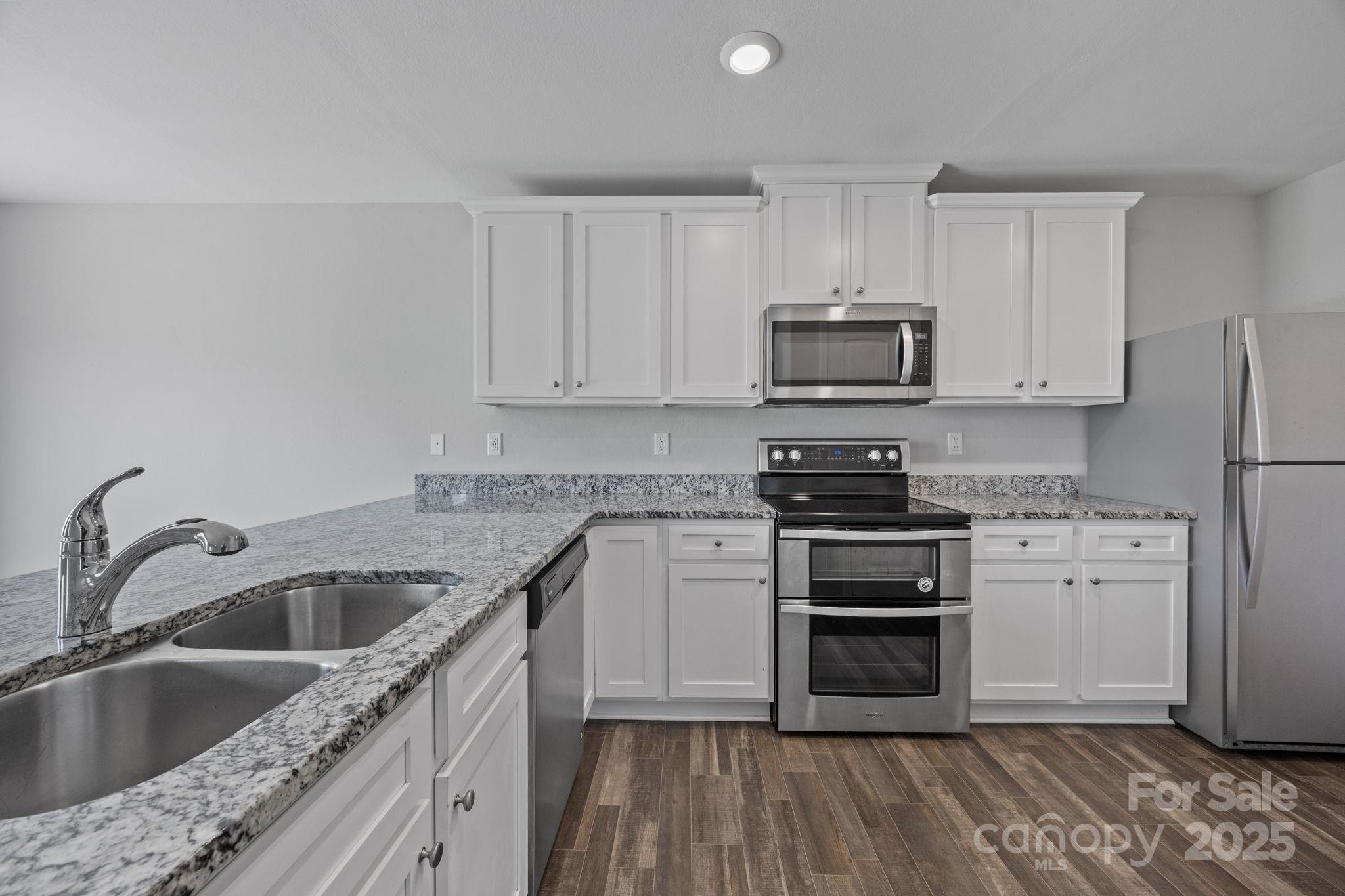 163 Kipling Lane Kings Mountain, NC 28086 - Photo 7 of 46 a kitchen with stainless steel appliances granite countertop a stove a sink and a refrigerator