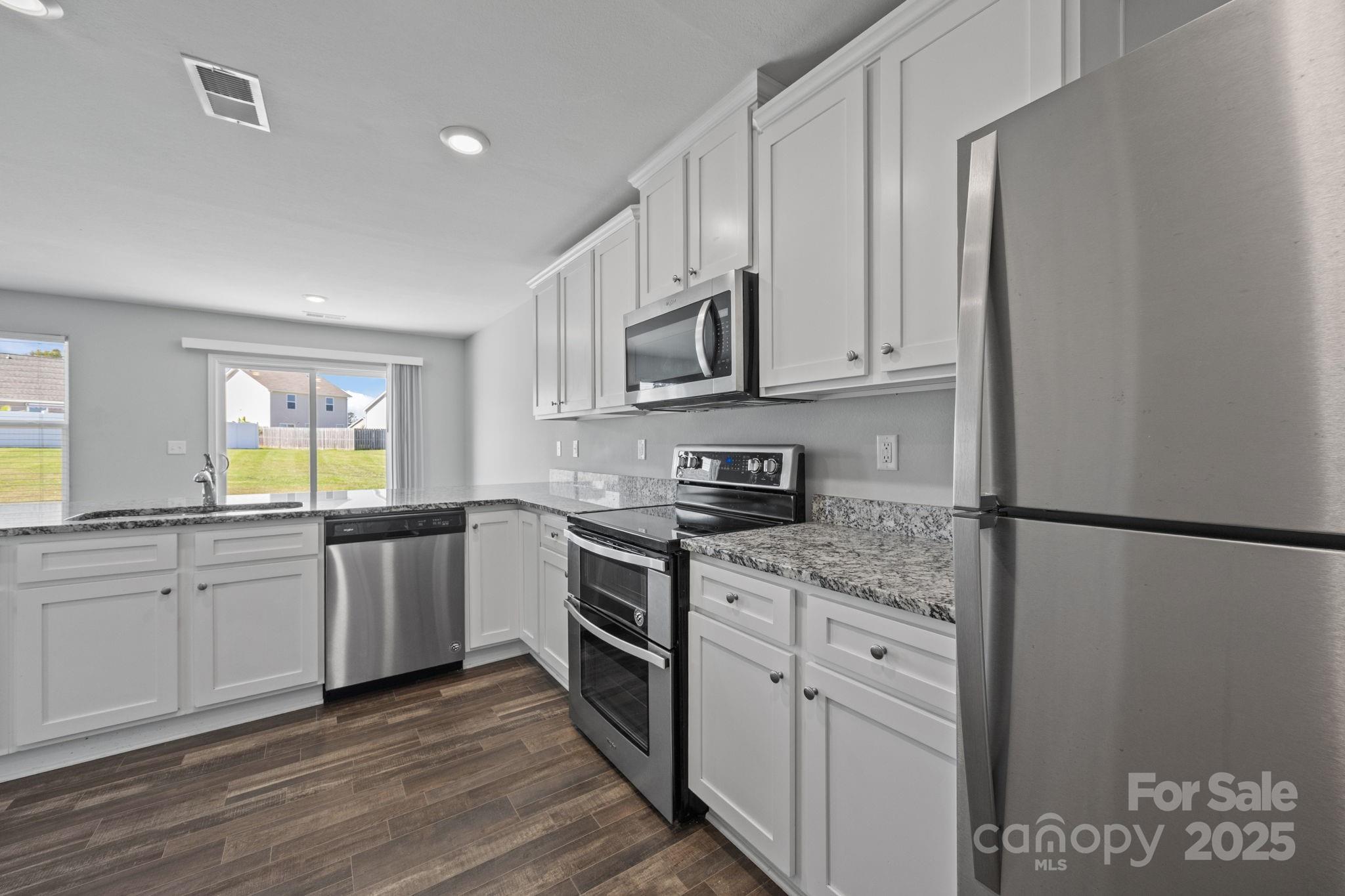 163 Kipling Lane Kings Mountain, NC 28086 - Photo 9 of 46 a kitchen with stainless steel appliances granite countertop a stove a sink and a refrigerator