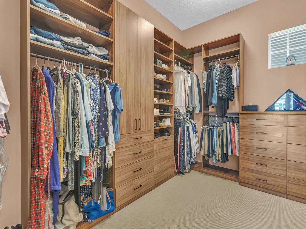 9220 Spring Time Drive Vero Beach, FL 32963 - Photo 14 of 28 a view of walk in closet with clothes