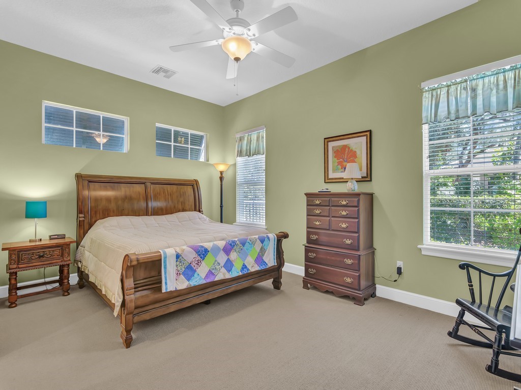 9220 Spring Time Drive Vero Beach, FL 32963 - Photo 16 of 28 a bedroom with a bed chair and a window