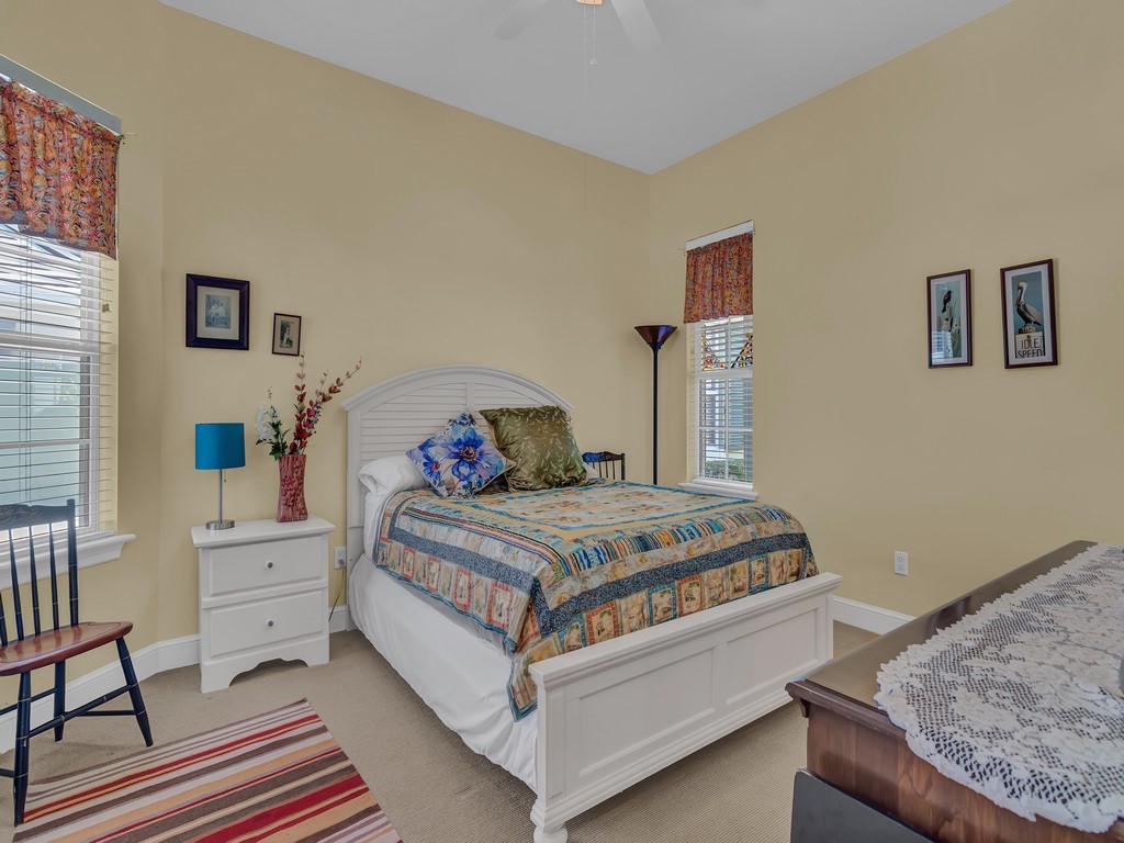 9220 Spring Time Drive Vero Beach, FL 32963 - Photo 17 of 28 a bedroom with a bed and window