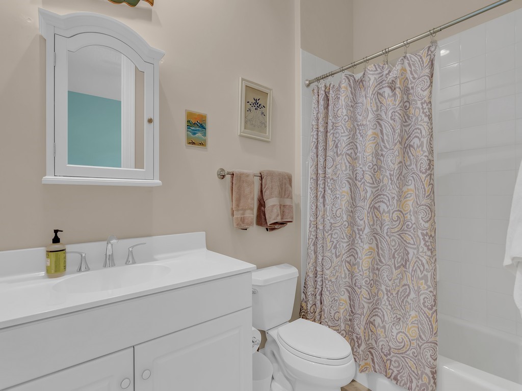 9220 Spring Time Drive Vero Beach, FL 32963 - Photo 18 of 28 a bathroom with a sink a toilet and shower curtain