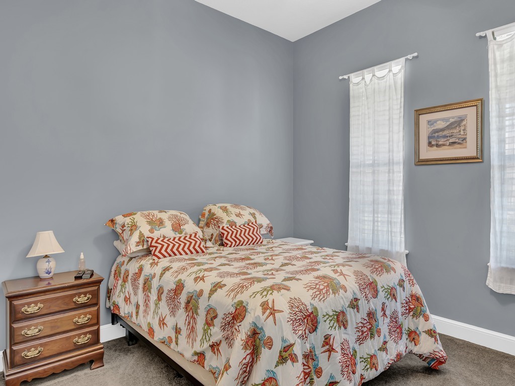 9220 Spring Time Drive Vero Beach, FL 32963 - Photo 22 of 28 a bedroom with a bed and a lamp on dresser