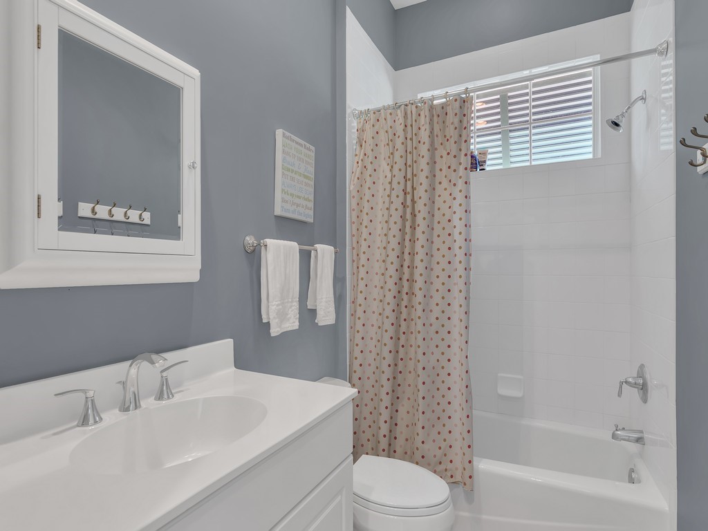 9220 Spring Time Drive Vero Beach, FL 32963 - Photo 23 of 28 a bathroom with a sink a toilet and shower