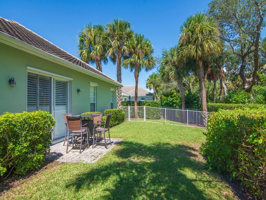 9220 Spring Time Drive Vero Beach, FL 32963 - Photo 24 of 28 a view of a chair and table in backyard