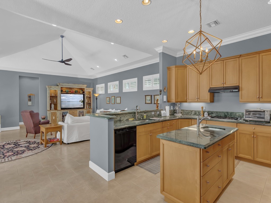 9220 Spring Time Drive Vero Beach, FL 32963 - Photo 6 of 28 a kitchen with a sink stove and microwave
