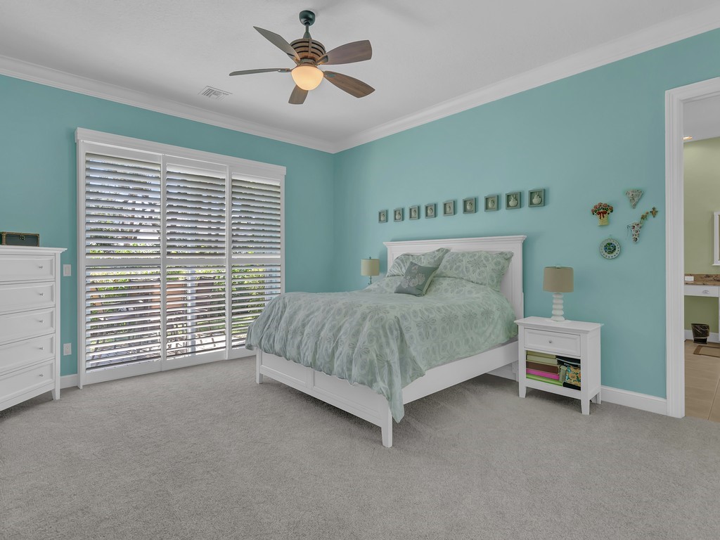 9220 Spring Time Drive Vero Beach, FL 32963 - Photo 10 of 28 a bedroom with a bed and a ceiling fan