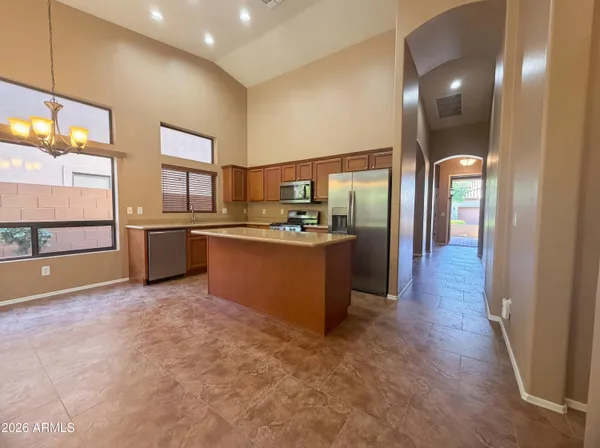 a kitchen with stainless steel appliances granite countertop a refrigerator and a sink