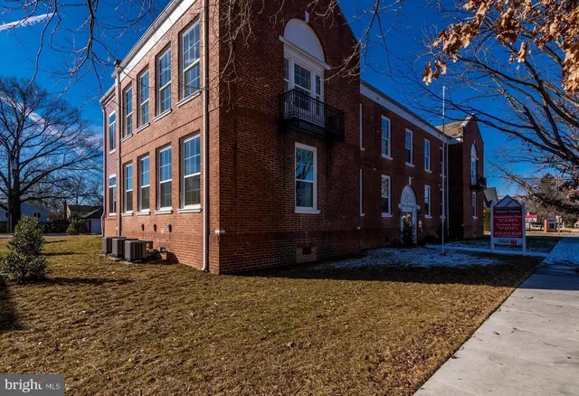 a view of a building with a yard