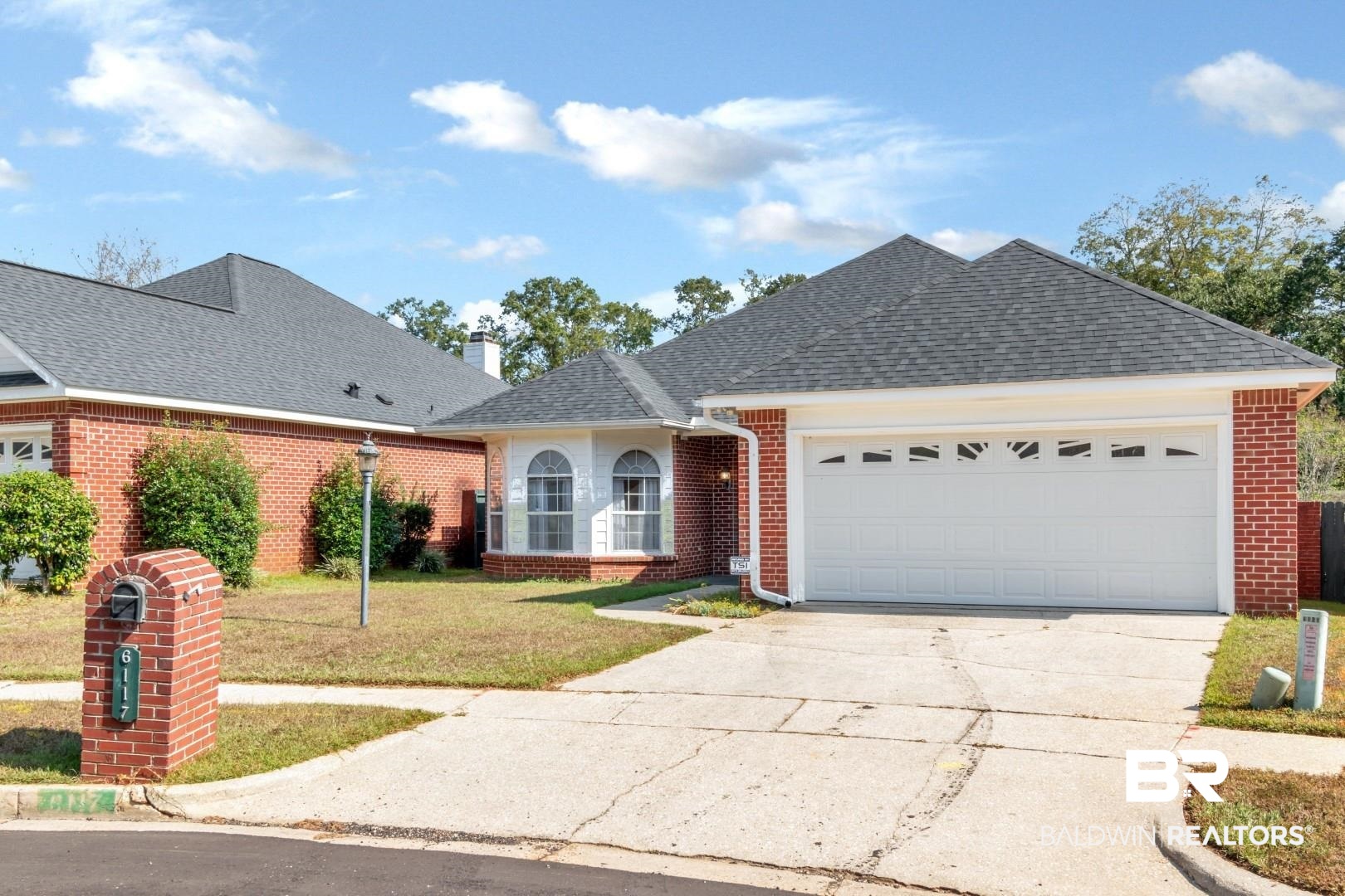 6117 Lennox Place Mobile, AL 36693 - Photo 1 of 39 Ranch-style house featuring brick siding, a garage, a front lawn, and concrete driveway