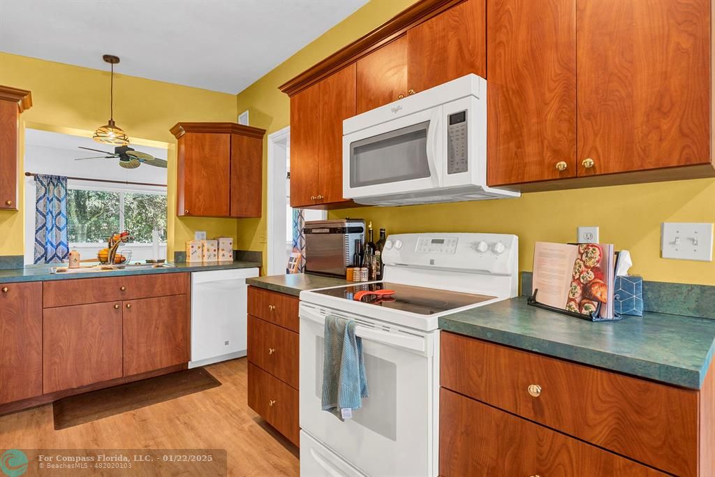 5751 Pine Terrace Plantation, FL 33317 - Photo 11 of 35 a kitchen with stainless steel appliances granite countertop a sink stove and cabinets