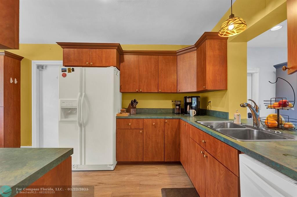 5751 Pine Terrace Plantation, FL 33317 - Photo 12 of 35 a kitchen with stainless steel appliances granite countertop a refrigerator and a sink