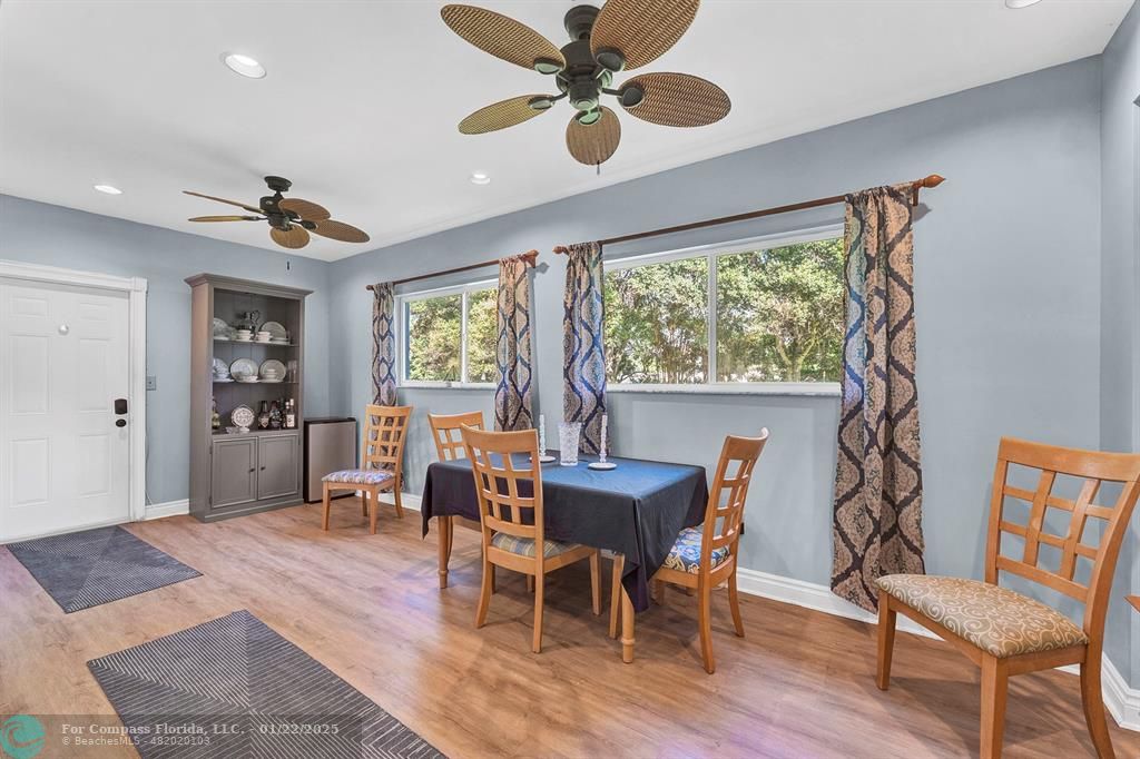 5751 Pine Terrace Plantation, FL 33317 - Photo 18 of 35 a dining room with wooden floor a chandelier fan a wooden table and chairs