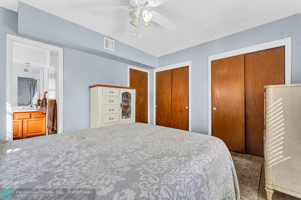 5751 Pine Terrace Plantation, FL 33317 - Photo 21 of 35 a bedroom with a large bed and a chandelier