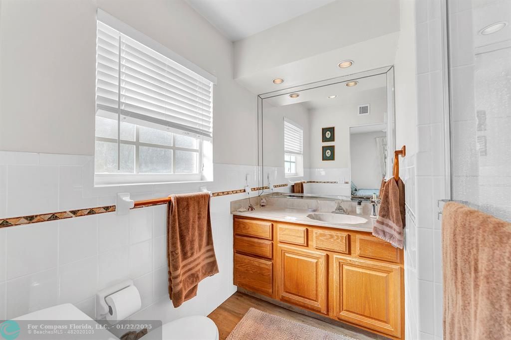 5751 Pine Terrace Plantation, FL 33317 - Photo 22 of 35 a bathroom with a sink a mirror and a toilet