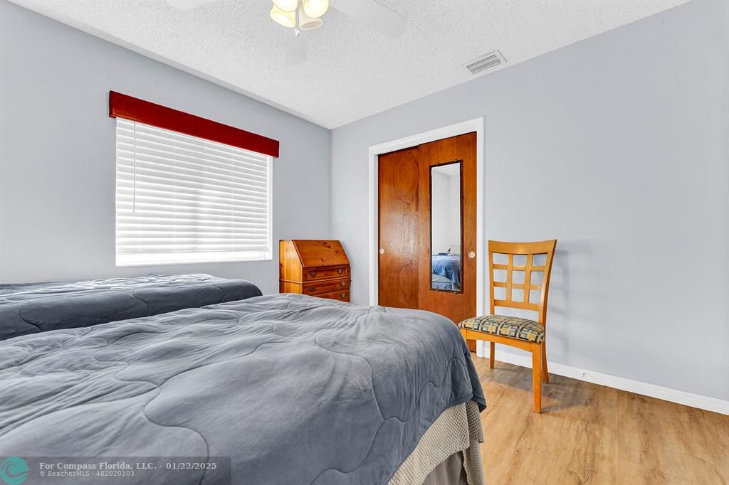 5751 Pine Terrace Plantation, FL 33317 - Photo 27 of 35 a bedroom with a bed and a dresser next to a window