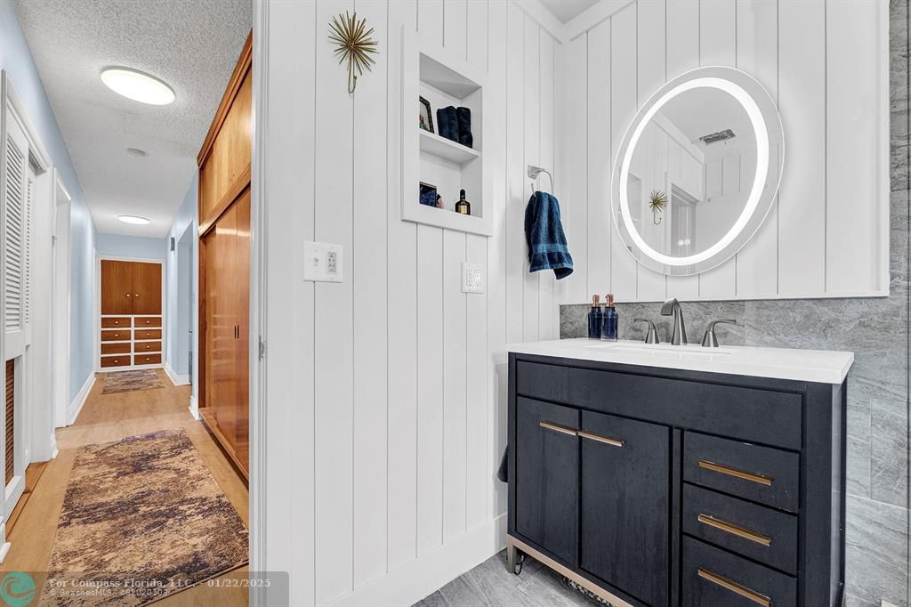 5751 Pine Terrace Plantation, FL 33317 - Photo 29 of 35 a bathroom with a sink a vanity and a mirror