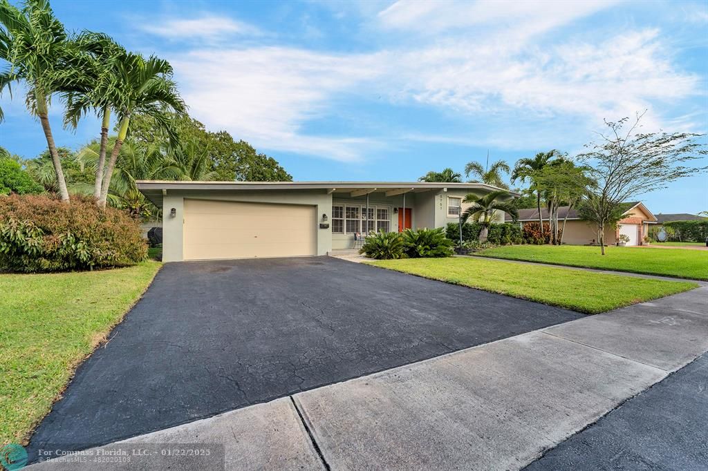5751 Pine Terrace Plantation, FL 33317 - Photo 8 of 35 a front view of a house with a yard and trees