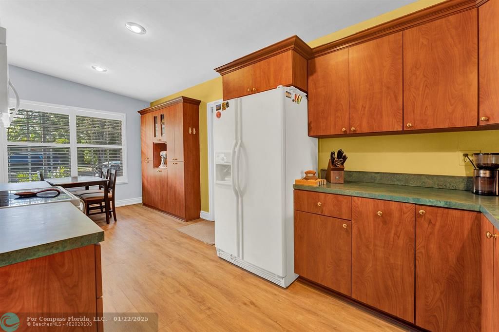 5751 Pine Terrace Plantation, FL 33317 - Photo 10 of 35 a kitchen with a refrigerator a stove a sink dishwasher and wooden cabinets with wooden floor
