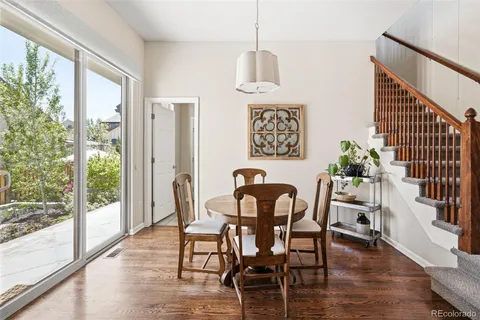 a view of a dining room with furniture window and wooden floor