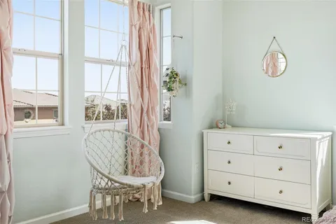 a bedroom with a bed couch and a window