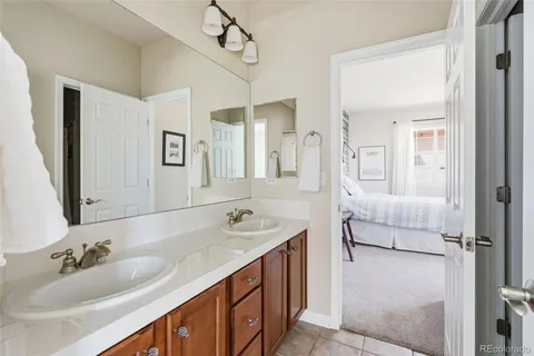 a bathroom with a sink a toilet a mirror and vanity