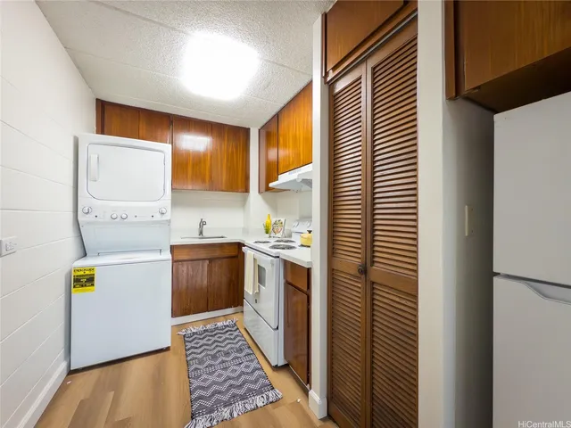 a kitchen with a stove a sink and a refrigerator