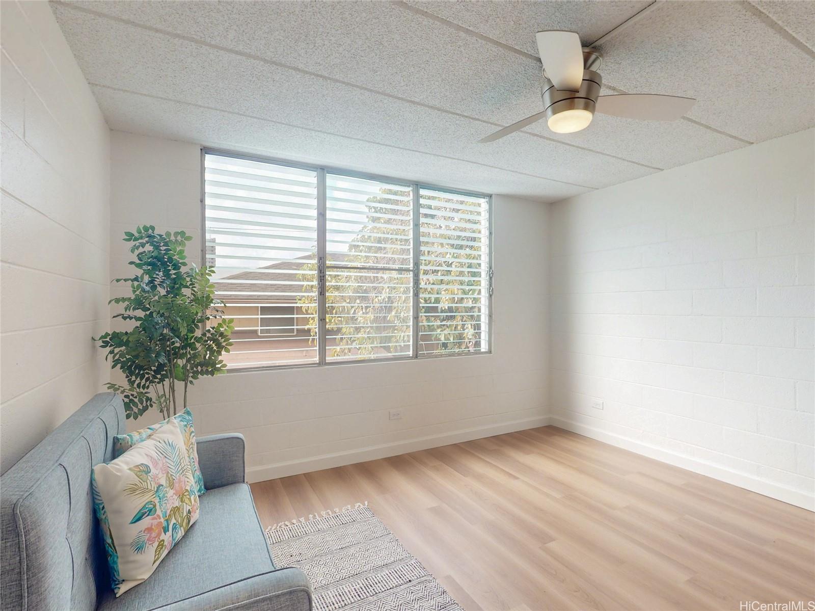 2015 Wilder Avenue, Unit 2E Honolulu, HI 96822 - Photo 4 of 12 a view of an empty room with a window and a potted plant