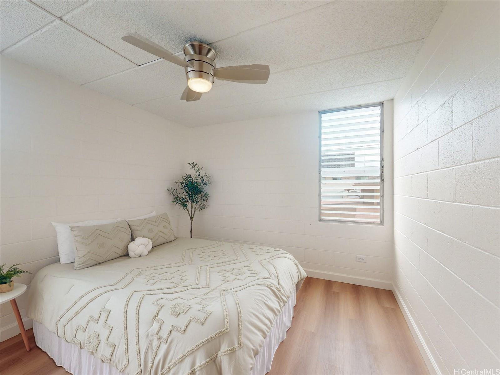 2015 Wilder Avenue, Unit 2E Honolulu, HI 96822 - Photo 5 of 12 a bedroom with a bed and a window