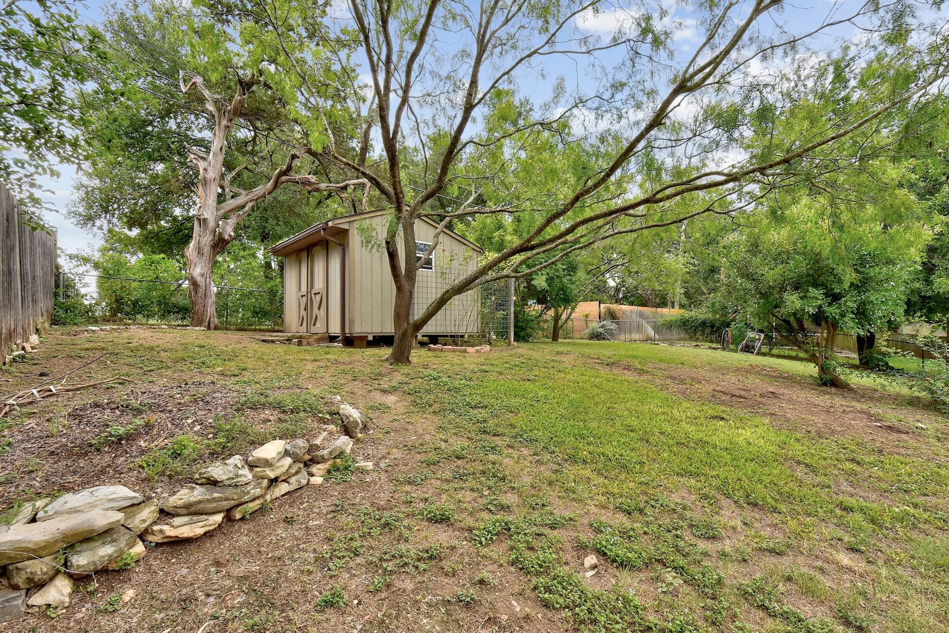 2117 A Rabb Road Austin, TX 78704 - Photo 20 of 21 Mature trees shade a spacious grassy backyard complete with a storage shed.