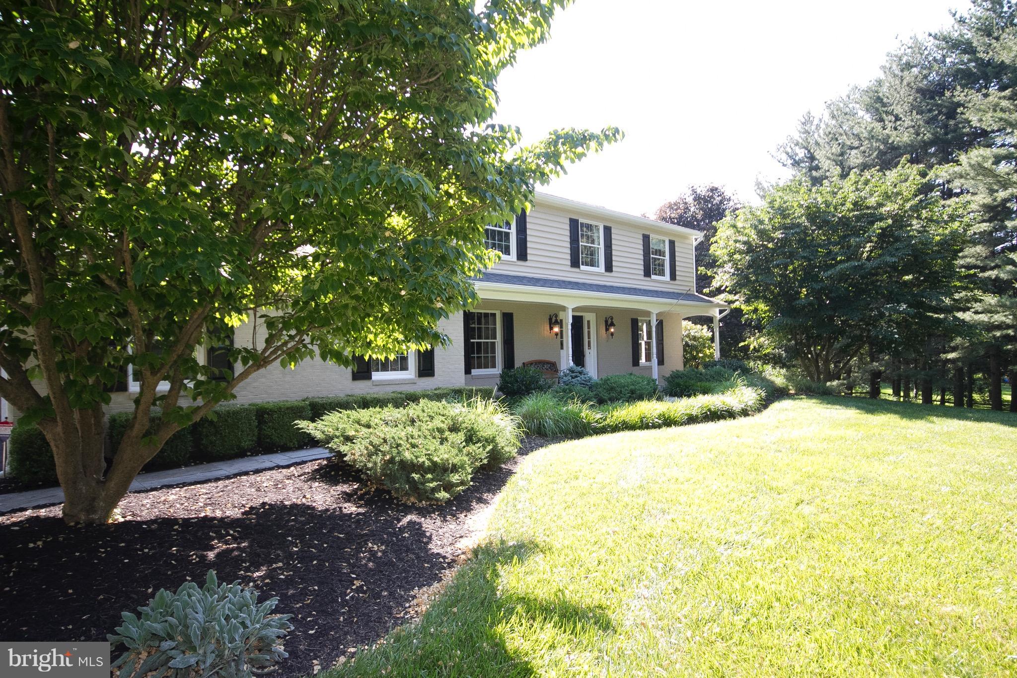 1907 Ridge Road Reisterstown, MD 21136 - Photo 2 of 27 a front view of a house with a yard and shrubs