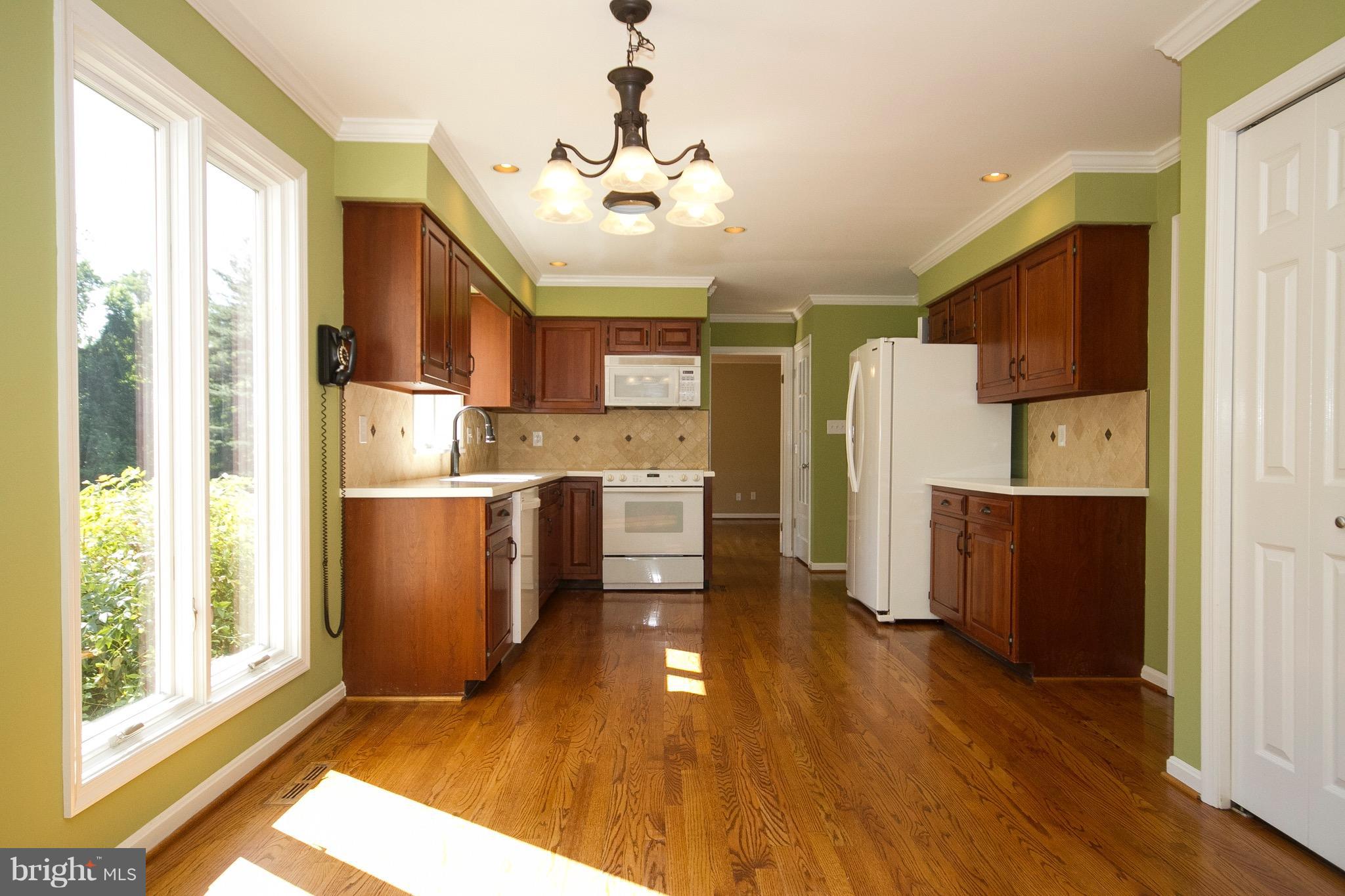 1907 Ridge Road Reisterstown, MD 21136 - Photo 25 of 27 a kitchen with kitchen island wooden floors appliances and cabinets