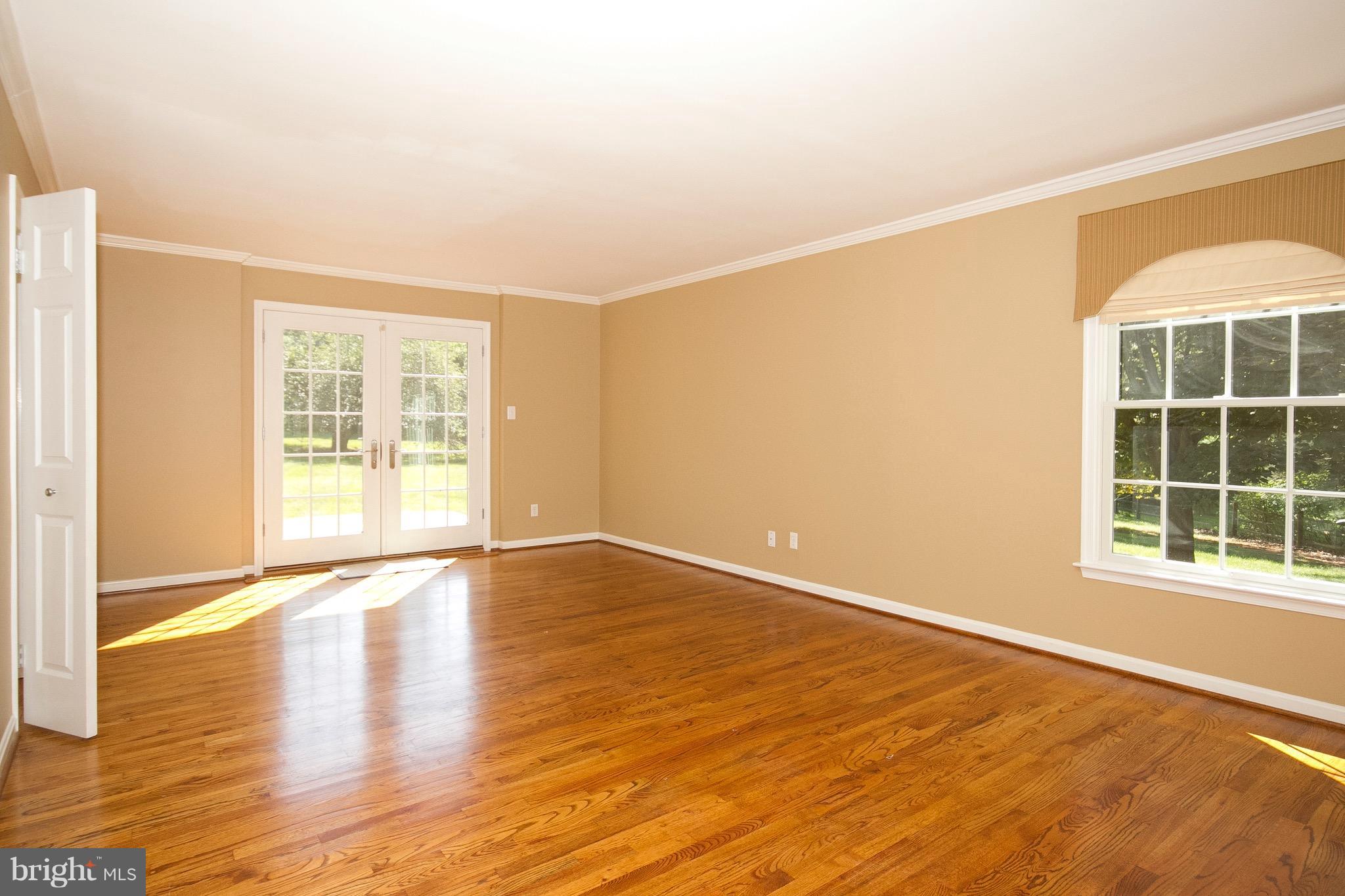 1907 Ridge Road Reisterstown, MD 21136 - Photo 9 of 27 a view of an empty room with wooden floor and a window