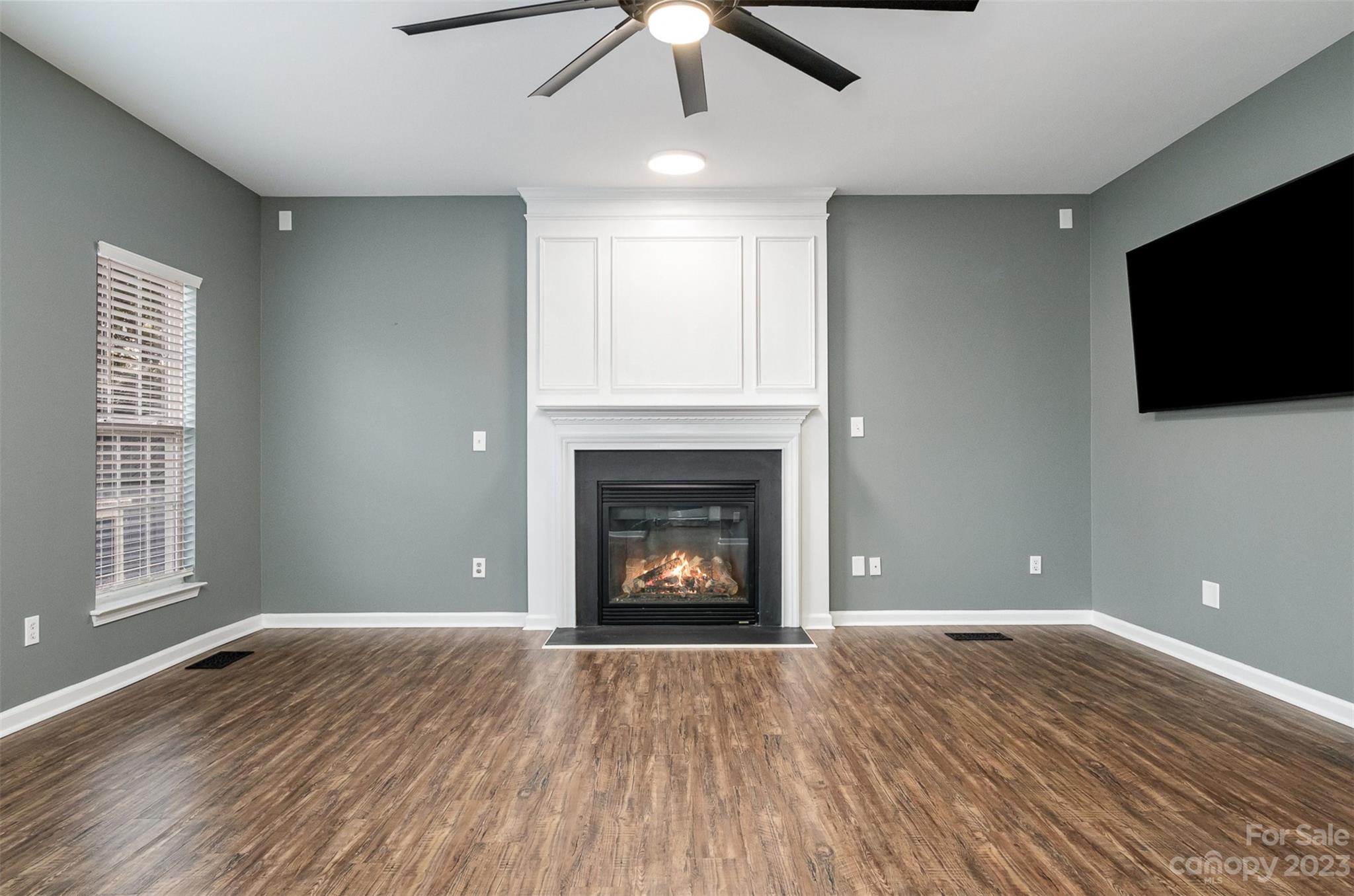 765 Knightswood Road Fort Mill, SC 29708 - Photo 13 of 41 a view of an empty room with wooden floor fireplace and a window