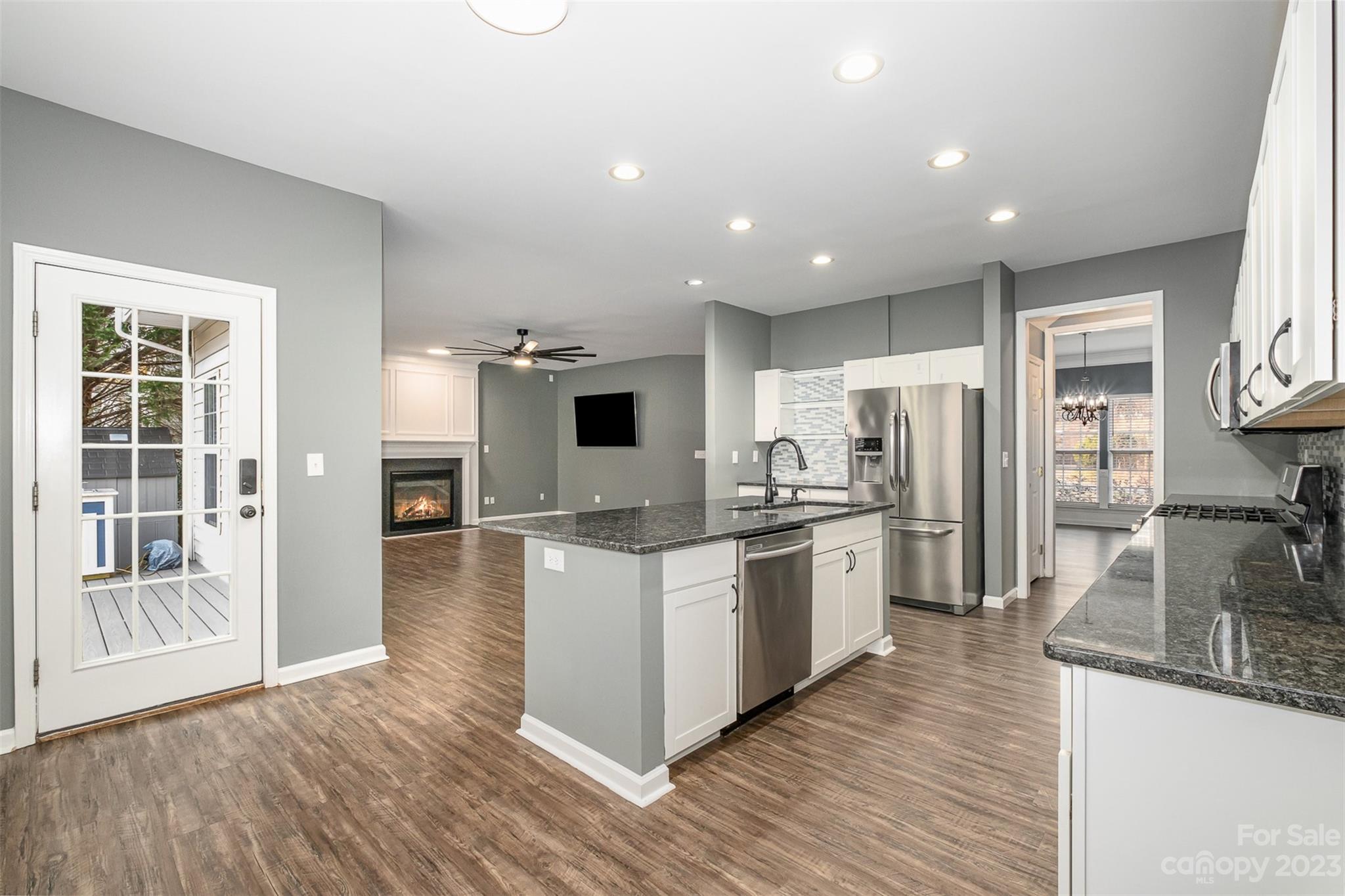 765 Knightswood Road Fort Mill, SC 29708 - Photo 16 of 41 a large kitchen with stainless steel appliances granite countertop a large counter top and wooden floors