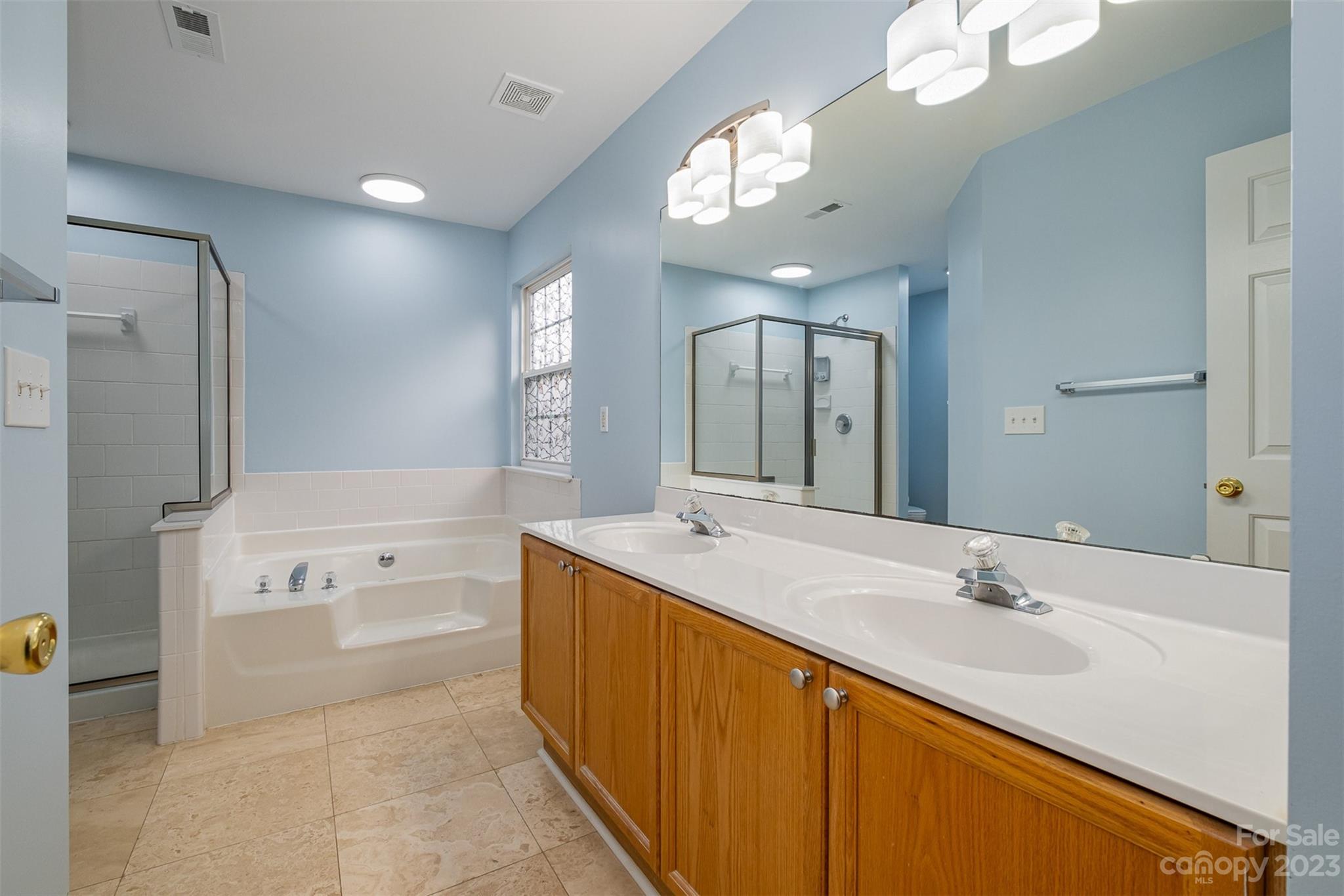 765 Knightswood Road Fort Mill, SC 29708 - Photo 23 of 41 a bathroom with a sink double vanity granite tub shower and a mirror