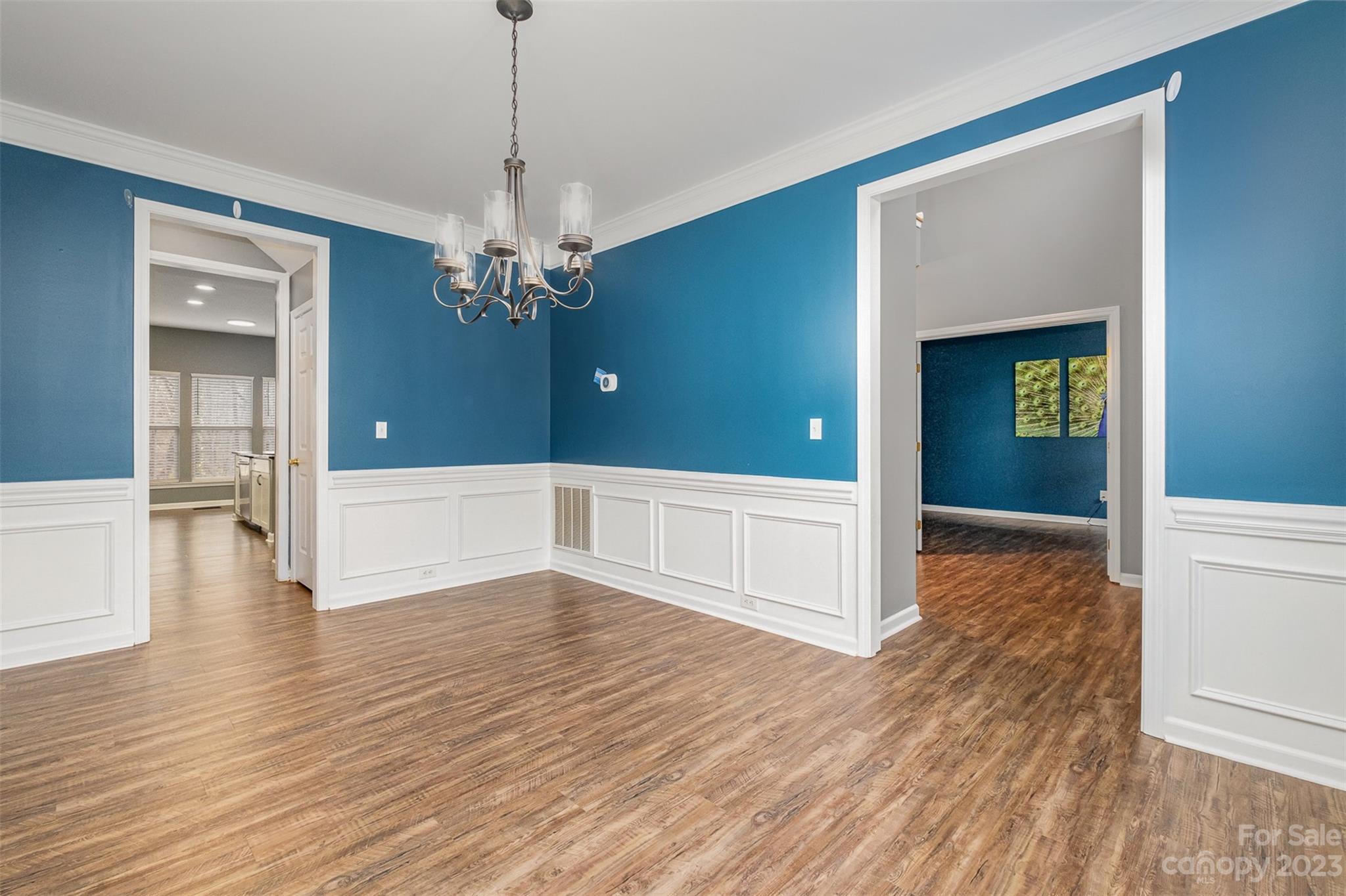 765 Knightswood Road Fort Mill, SC 29708 - Photo 9 of 41 a view of a livingroom with wooden floor staircase and a kitchen space
